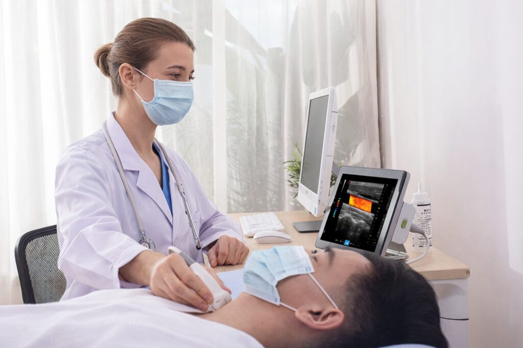 Doctor performing an examination of a patient's throat area using the Wisonic Piloter Ultrasound System