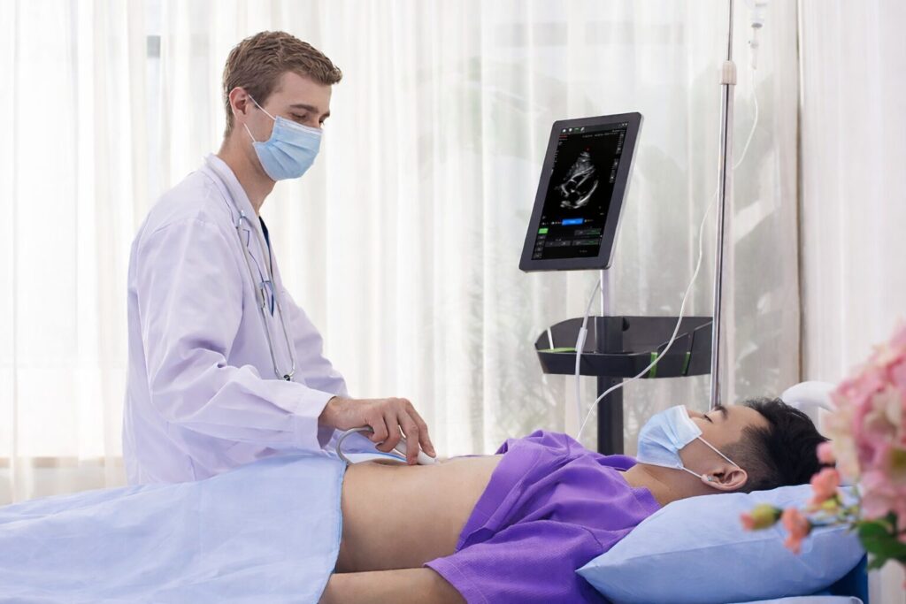 Doctor performing an examination of a patient's stomach using the Wisonic Piloter Ultrasound System for diagnostic imaging