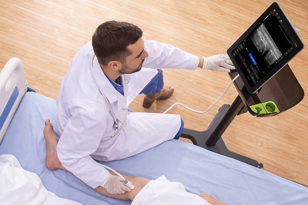 Doctor examining a patients leg with Wisonic Piloter Ultrasound System